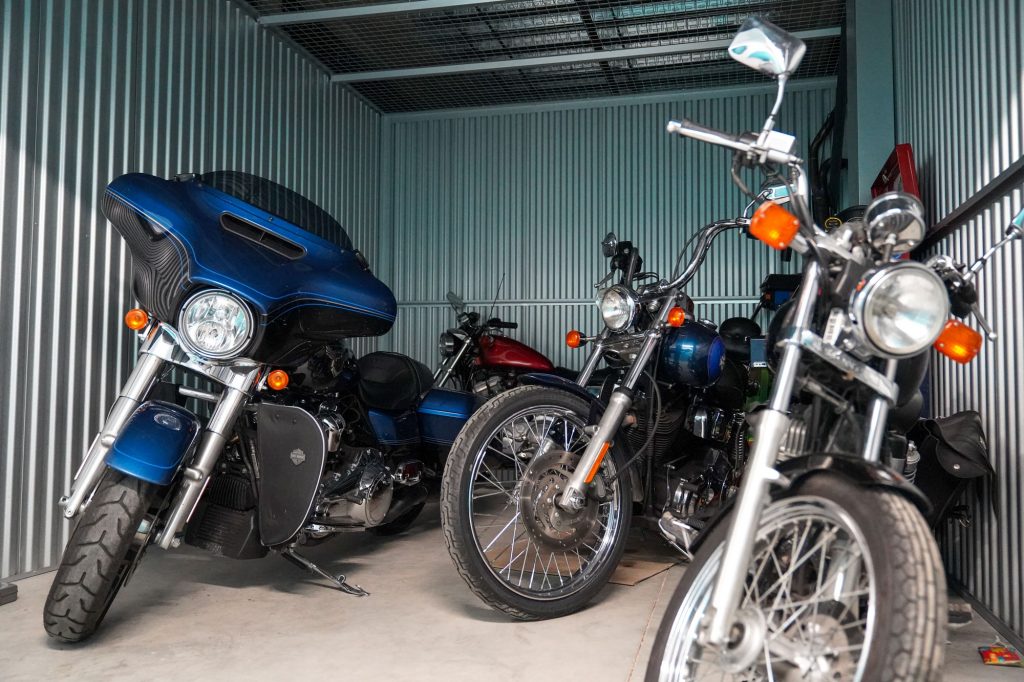 Five different motorcycles stored together in an indoor storage locker at UltraStor.