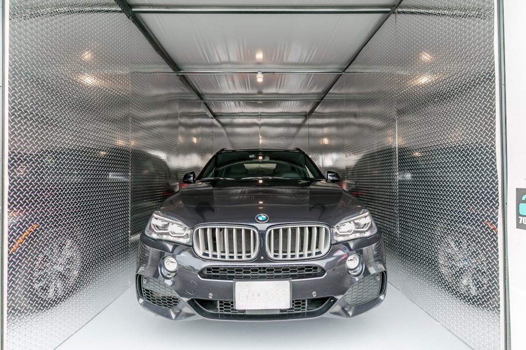 Black BMW car in secure, climate-control, drive-up UltraStor unit.