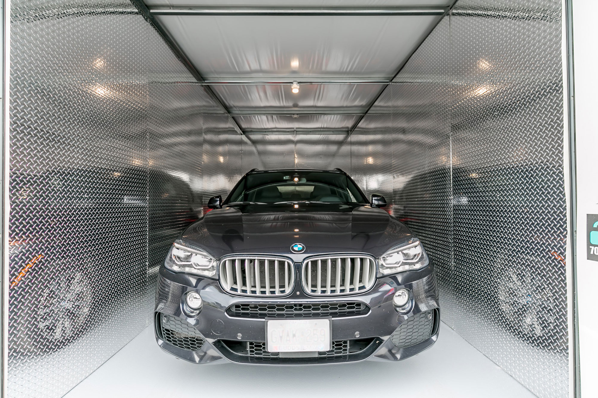 Black BMW car in secure, climate-control, drive-up UltraStor unit.