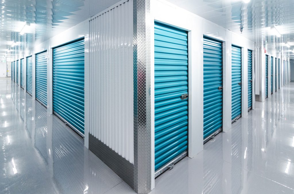 Two brightly-lit hallways, filled with rows of storage lockers at UltraStor.